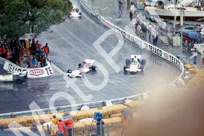 Beltoise moving through traffic W. Fittipaldi and Redman